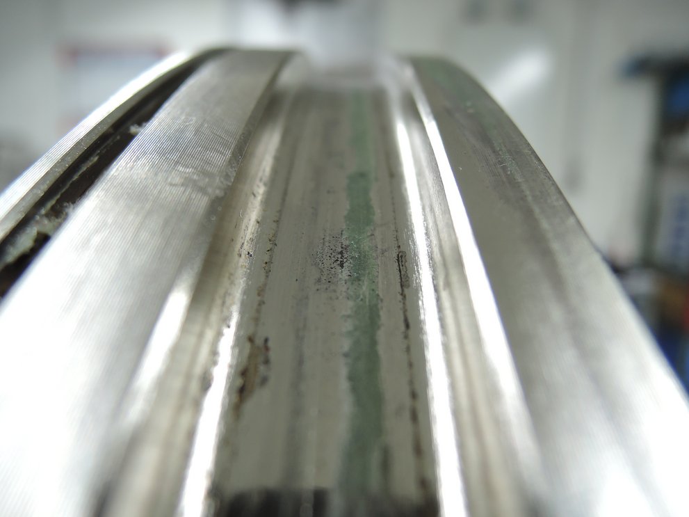 Signs of wear on the raceway of a used bearing
